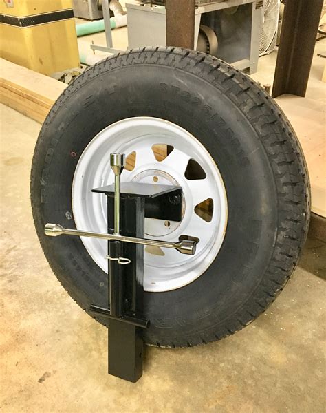 Magic tilt trailer spare tire mount